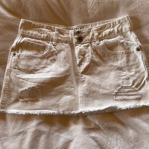Fun but sexy white denim mini with frey bottom and shred areas.